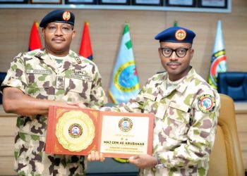 two soldiers standing side by side, holding an award